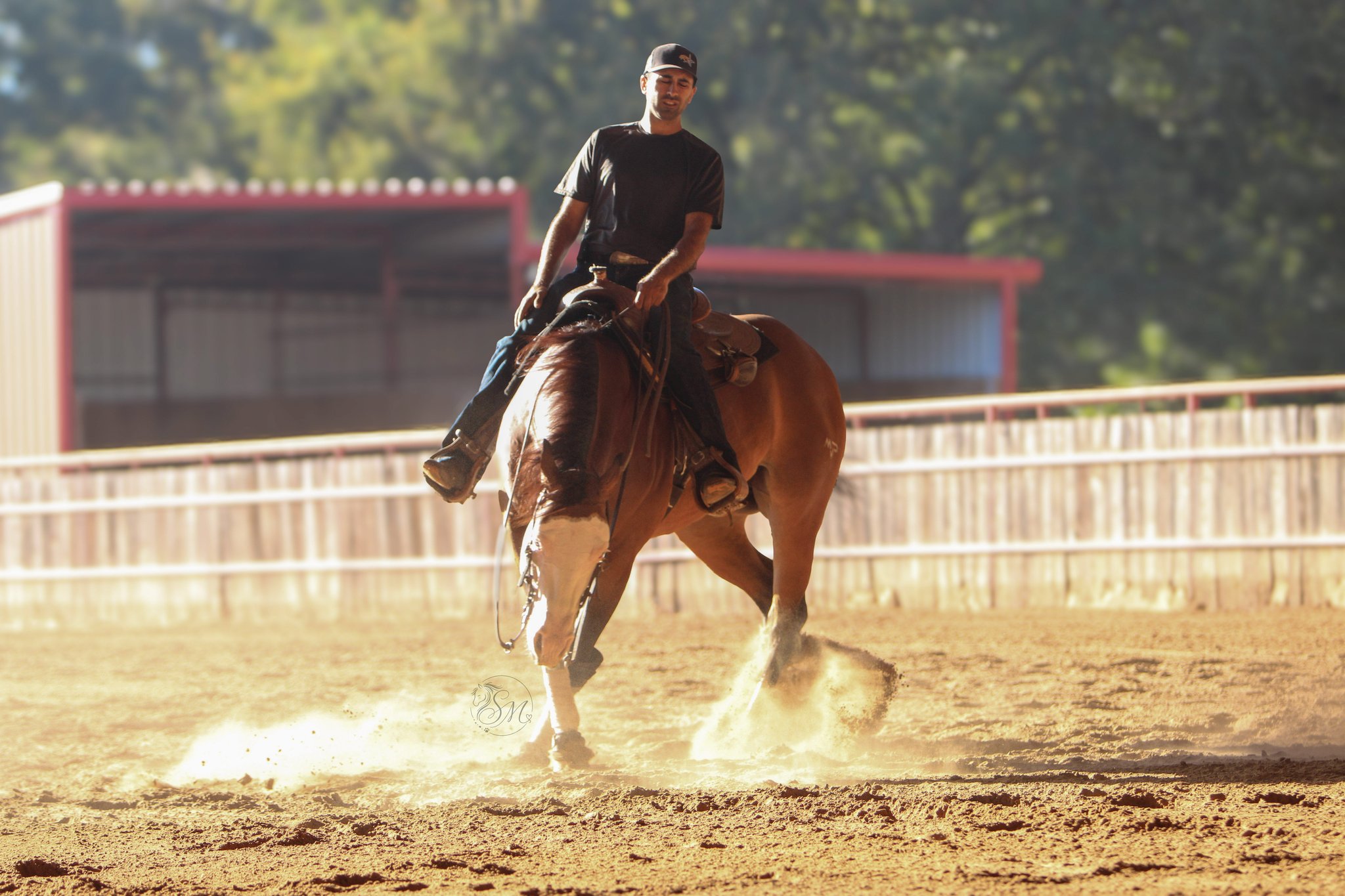 Vincienzo Santos riding Purple, a bay horse, through a turn in an outdoor arena